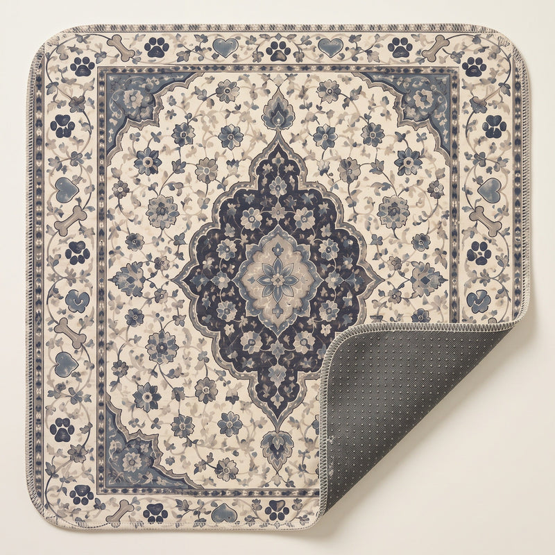 Ivory Paw Border washable pee pad, cream ground with a navy medallion and a paw and bone border, one corner turned
