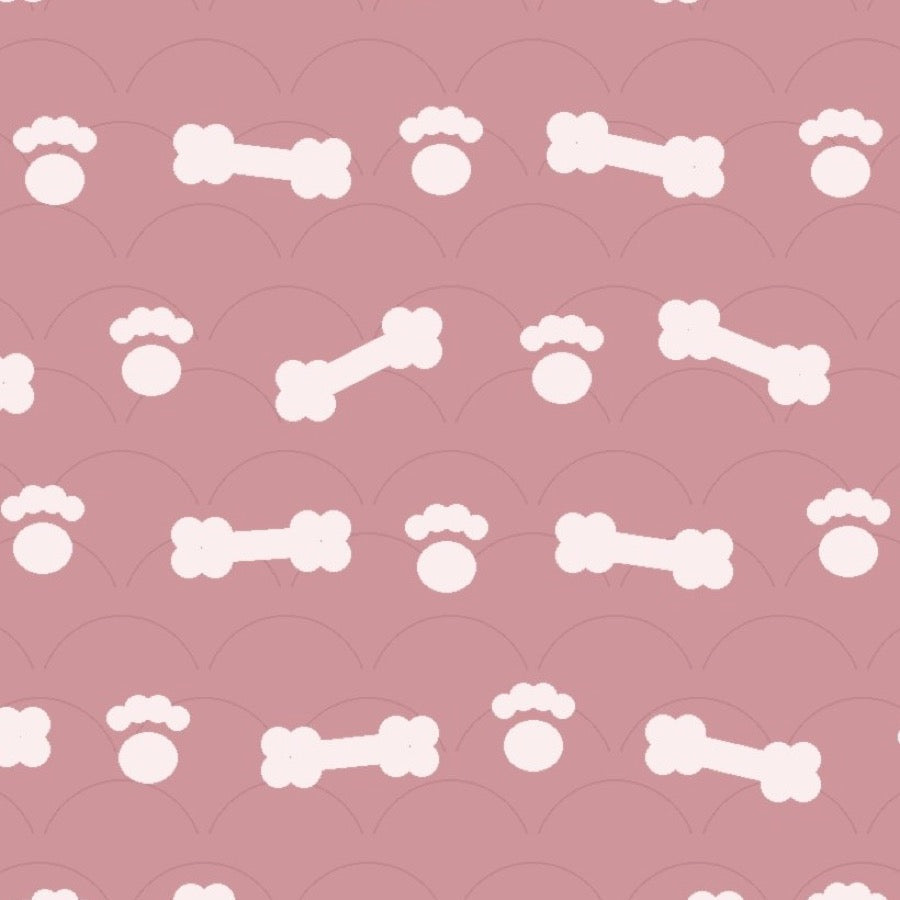 Blush pink print with white dog bones and paw prints over faint arches, used on the washable pee pad