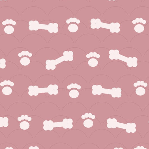 Blush pink print with white dog bones and paw prints over faint arches, used on the washable pee pad