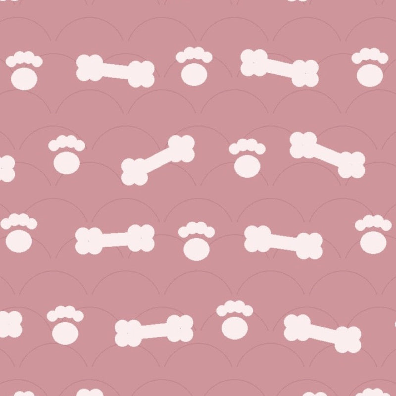 Blush pink print with white dog bones and paw prints over faint arches, used on the washable pee pad