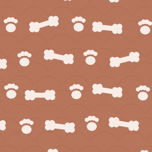 Clay brown print with cream dog bones and paw prints over faint arches, used on the washable pee pad