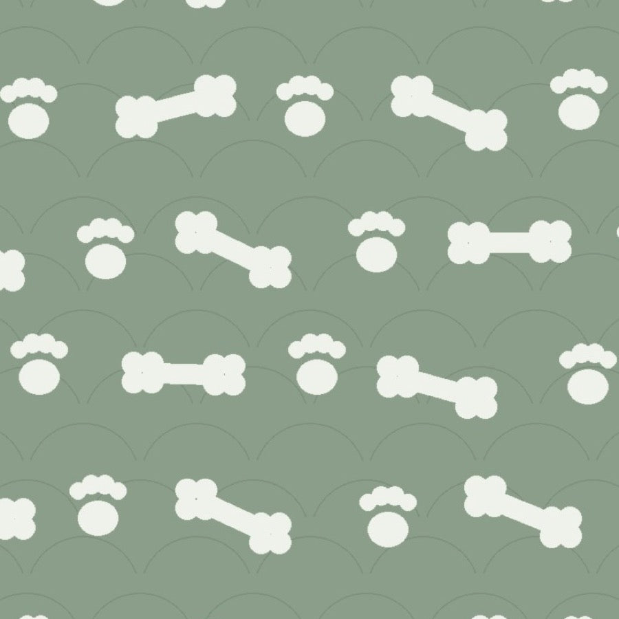 Sage green print with white dog bones and paw prints over faint arches, used on the washable pee pad