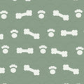 Sage green print with white dog bones and paw prints over faint arches, used on the washable pee pad