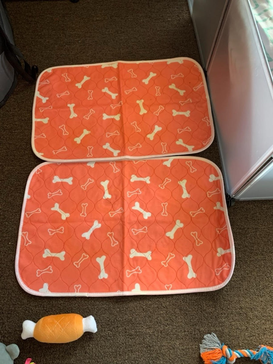 A Proper Pet washable pee pad laid flat on a hard floor, showing the anti-slip backing.